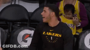 Man In Black Lakers Shirt Sitting In Stadium GIF