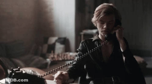 Man In Black Leather Jacket Talking On Phone GIF