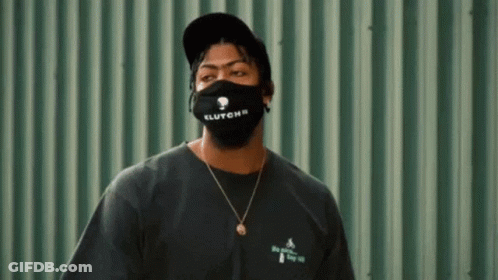 Man In Black Mask And Hat On Green Wall GIF