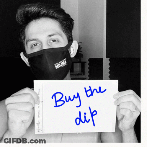 Man In Black Mask Holding Buy The Dip Sign GIF