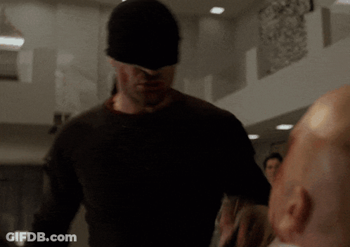 Man In Black Mask Standing Next To Another Man GIF