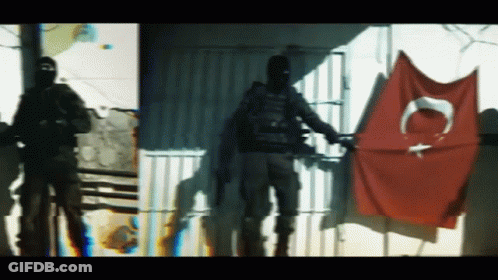 Man In Black Mask With Red Flag Letter C GIF