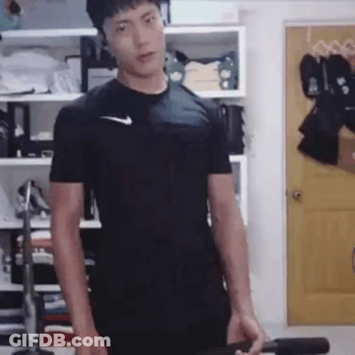 Man In Black Nike Holding Dumbbell At Yellow Door GIF