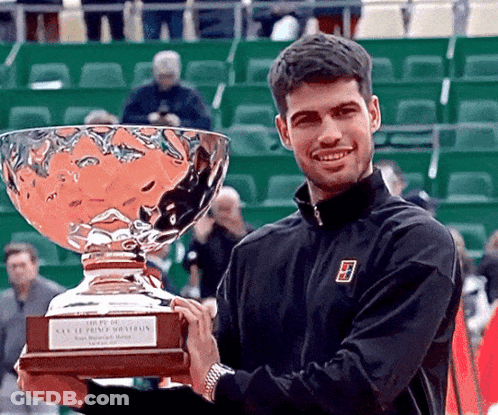 Man In Black Nike Jacket With Large Trophy GIF