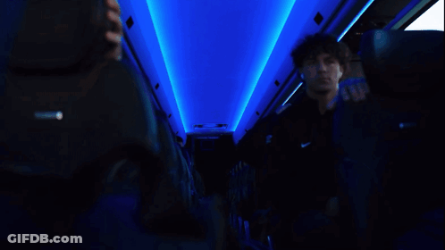 Man In Black Nike Shirt Looking At Phone GIF