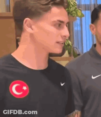 Man In Black Nike T-Shirt With Red Star And Crescent Moon GIF