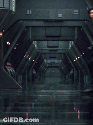 Man In Black Outfit Standing In Hallway GIF