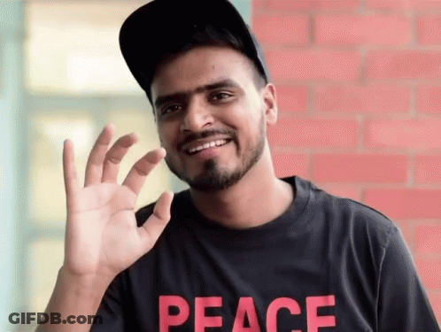 Man In Black Peace Shirt Smiling GIF