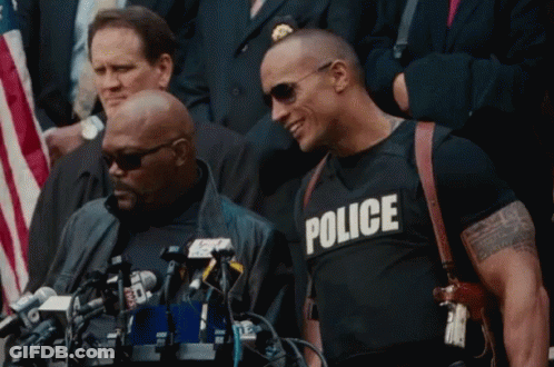 Man In Black Police Shirt At Microphones GIF
