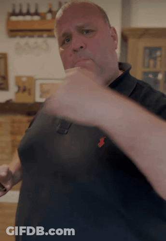 Man In Black Polo Shirt With Red Pony GIF