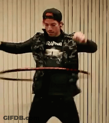 Man In Black Rammell Shirt Spinning Hula Hoop GIF