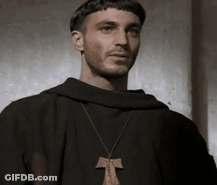 Man In Black Robe And Cross Necklace Looking GIF