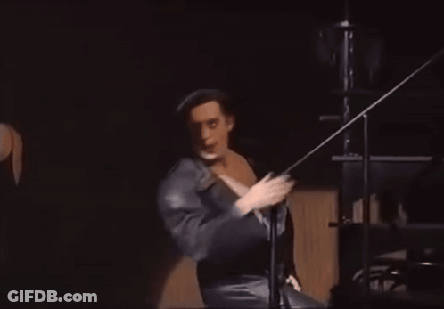 Man In Black Robe Dancing On Stage GIF