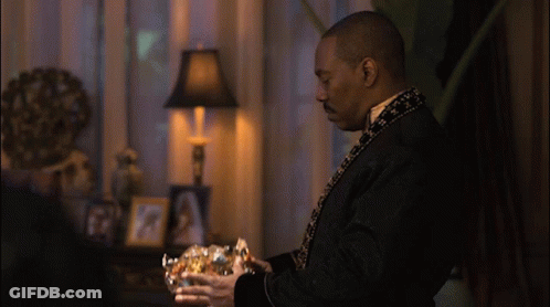 Man In Black Robe Holding Gold Bowl GIF