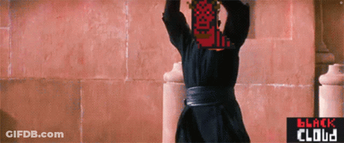 Man In Black Robe In Front Of Pink Wall GIF