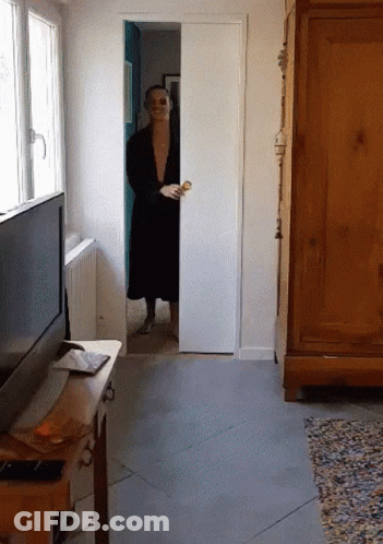 Man In Black Robe Peeking Out Of Sliding Door GIF