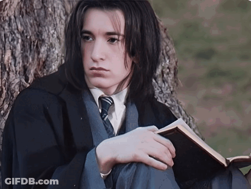 Man In Black Robe Standing In Front Of Window GIF