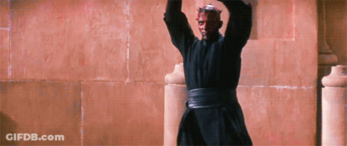 Man In Black Robe Standing With Arms Up GIF