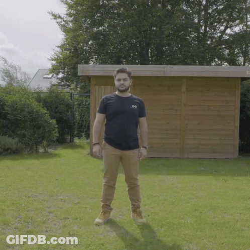 Man In Black SBS T-Shirt By Wooden Shed GIF