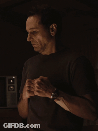 Man In Black Shirt Adjusting Wristwatch GIF