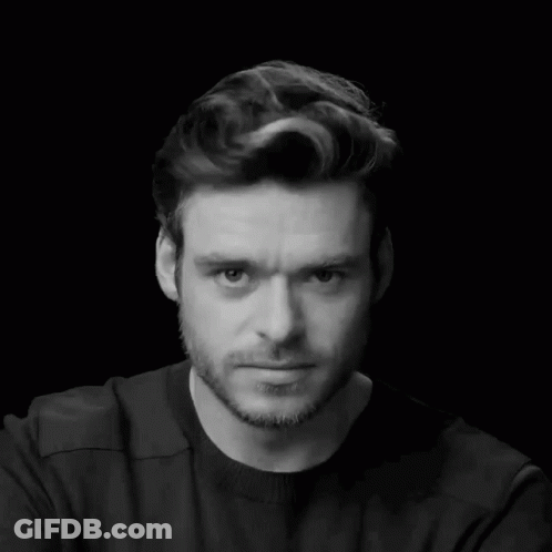 Man In Black Shirt And Beard Looking Down GIF