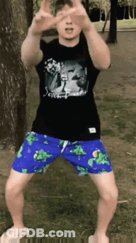 Man In Black Shirt And Blue Shorts In Park GIF
