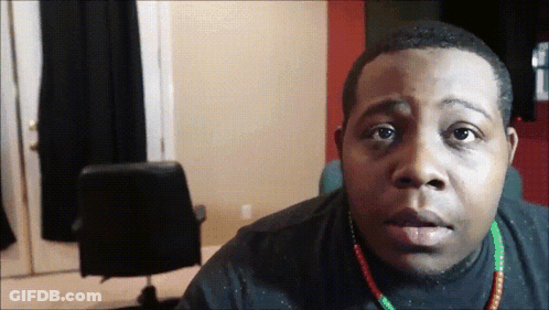 Man In Black Shirt And Green Red Necklace GIF