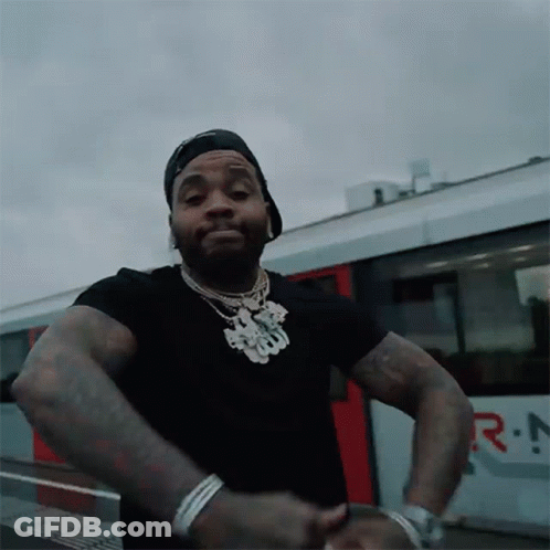Man In Black Shirt And Hat In Front Of Rio Train GIF