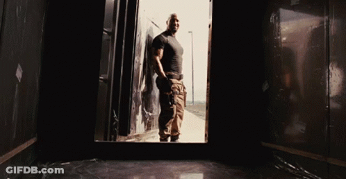 Man In Black Shirt And Khaki Pants In Dark Room GIF