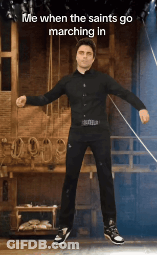 Man In Black Shirt And Pants On Stage Saying Me When The Saints Go Marching GIF
