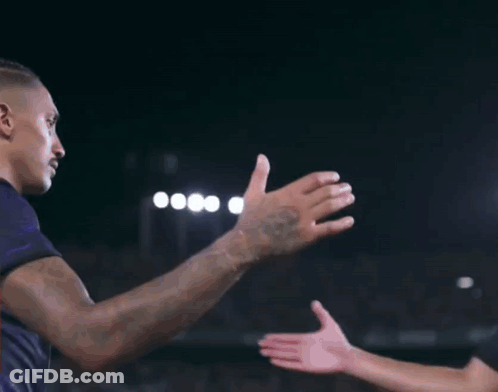 Man In Black Shirt And Purple Shorts Kneeling On Soccer Field GIF