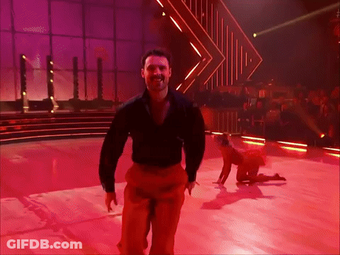 Man In Black Shirt And Red Pants Dancing On Stage GIF