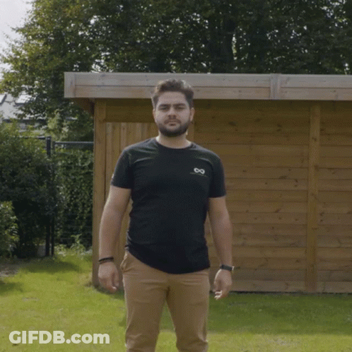 Man In Black Shirt And Tan Pants GIF
