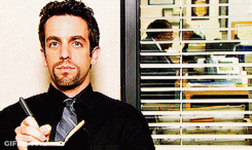 Man In Black Shirt And Tie Holding Notebook GIF