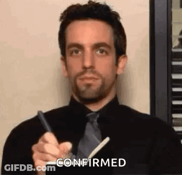 Man In Black Shirt And Tie Holding Pen GIF
