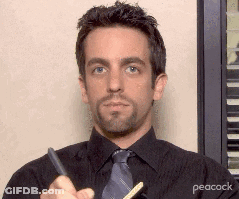 Man In Black Shirt And Tie Holding Pen And Pencil GIF