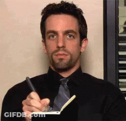 Man In Black Shirt And Tie Writing On Notebook GIF