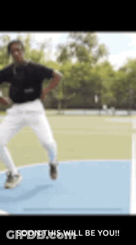 Man In Black Shirt And White Pants Jumping GIF