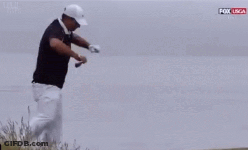 Man In Black Shirt And White Pants Kneeling With Golf Club GIF