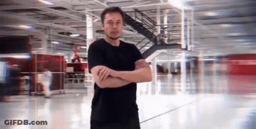 Man In Black Shirt Arms Crossed In Empty Building GIF