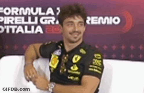 Man In Black Shirt Arms Crossed Smiling On Couch GIF