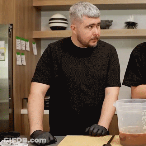 Man In Black Shirt At Cutting Board GIF