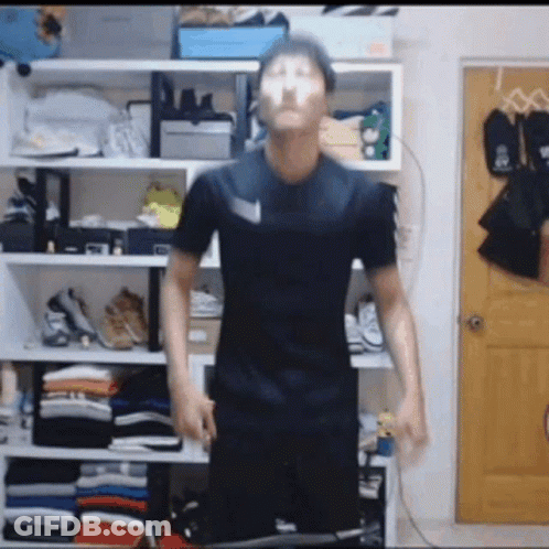 Man In Black Shirt Before Closet Full Of Clothes And Shoes GIF