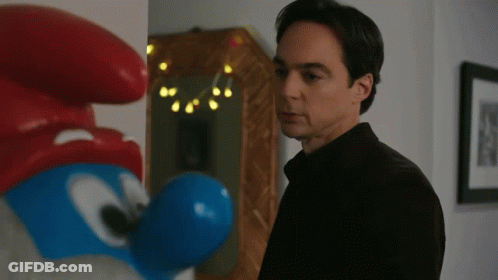 Man In Black Shirt Beside Smurf Statue GIF