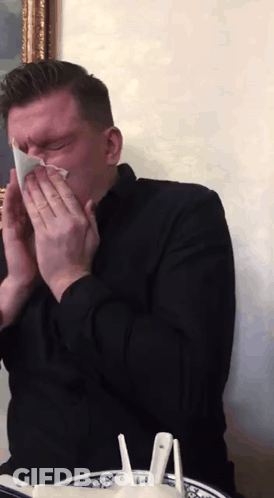 Man In Black Shirt Blowing His Nose GIF