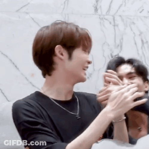 Man In Black Shirt Clapping While Another Man Watches GIF