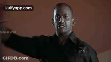 Man In Black Shirt Covering Eyes With Blood On Face GIF