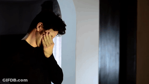 Man In Black Shirt Covering Face GIF
