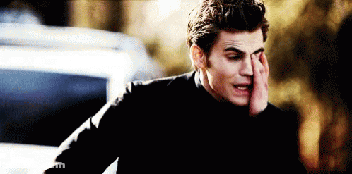 Man In Black Shirt Covering Face By Car GIF