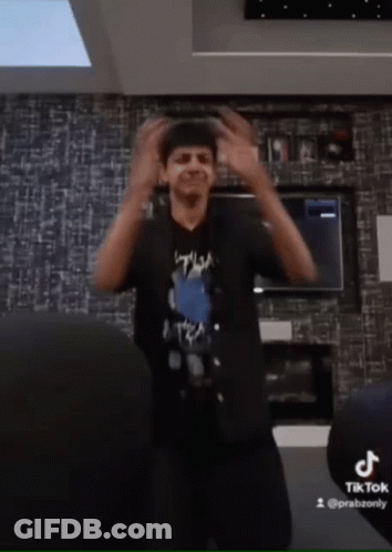 Man In Black Shirt Dancing By TikTok Logo GIF